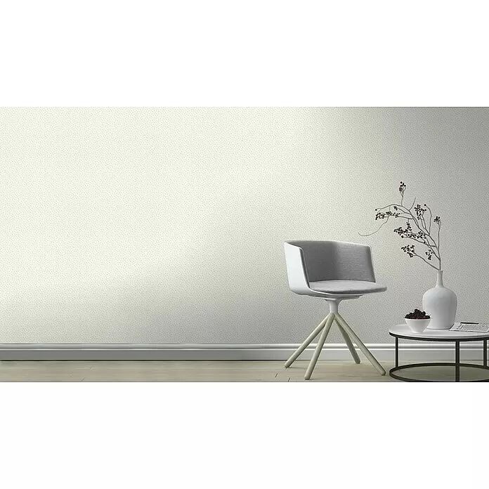 Rasch Bambino XIX Vliestapete Pünktchen - Weiß-Grau, Grafisch, 10,05 x 0,53 m - Helle beige Tapete mit zartem Punktmuster, die eine Wand in einem modernen Raum mit Stuhl und Tisch schmückt.