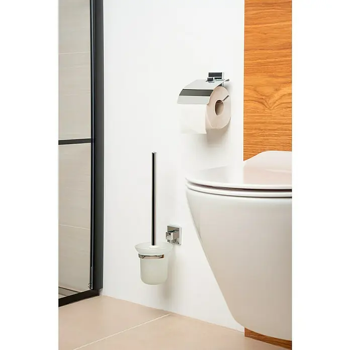 Venus Salmo WC-Bürstengarnitur - Mit Halterung, Edelstahl, Glänzend - Eine Nahaufnahme eines modernen Badezimmers mit einer eleganten Toilettenbürste und einem Toilettenpapierhalter an der weißen Wand.
