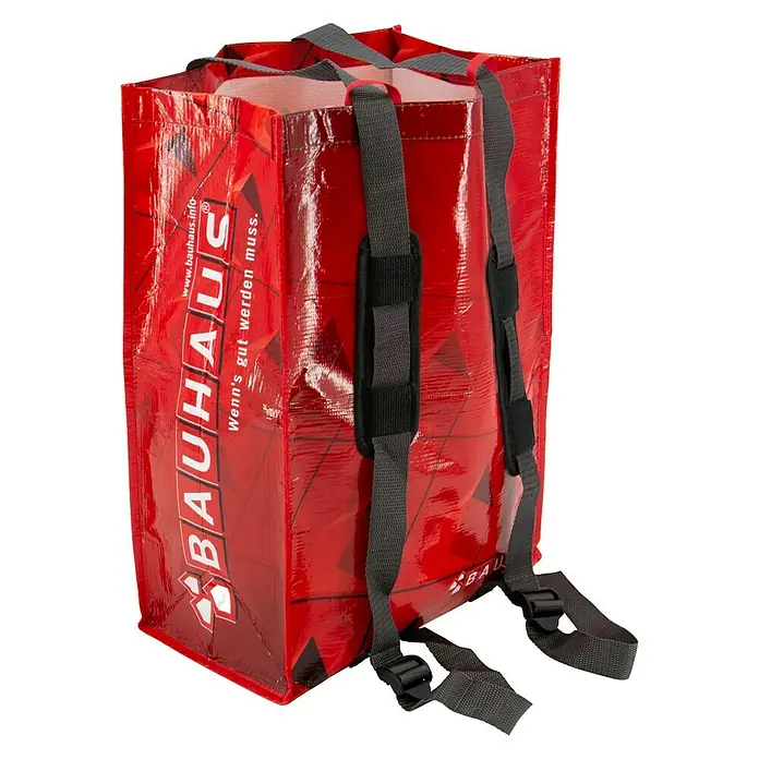 Fahrradtasche BAUHAUS BERLIN SKYLINE - Rot, Traglast: 15 kg, 30 l - Eine rote Bauhaus-Einkaufstasche mit grauen Trägern, die als Rucksack getragen werden kann. Praktisch und robust für Einkäufe.