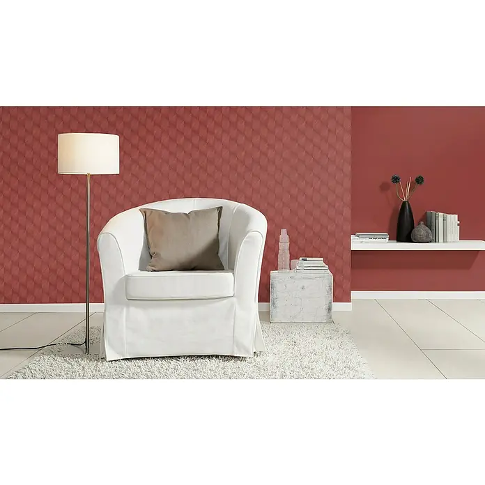 Rasch Tropical House Vliestapete - Ziegelrot, Uni, 10,05 x 0,53 m - Einrichtungsidee mit einem weißen Sessel mit Kissen, einer Stehlampe und Dekorationselementen in einem stilvollen, modern eingerichteten Wohnzimmer.