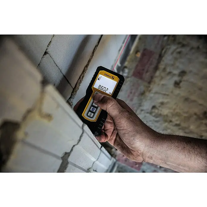 Stabila Laserentfernungsmesser LD 250 BT - Max. Arbeitsbereich: 50 m - Hand hält einen gelben Stabila Laser-Entfernungsmesser, der 8,602 m an einer Wand anzeigt. Präzises Messen leicht gemacht.