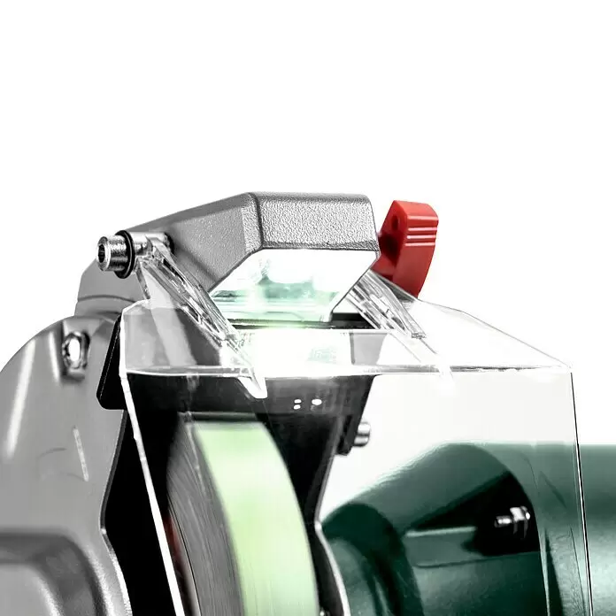 Metabo Band- & Tellerschleifer BS 200 Plus - 600 W, 2.980 U/min - Nahaufnahme einer transparenten Schutzhaube eines Schleifbocks mit integriertem LED-Licht und rotem Verstellgriff.