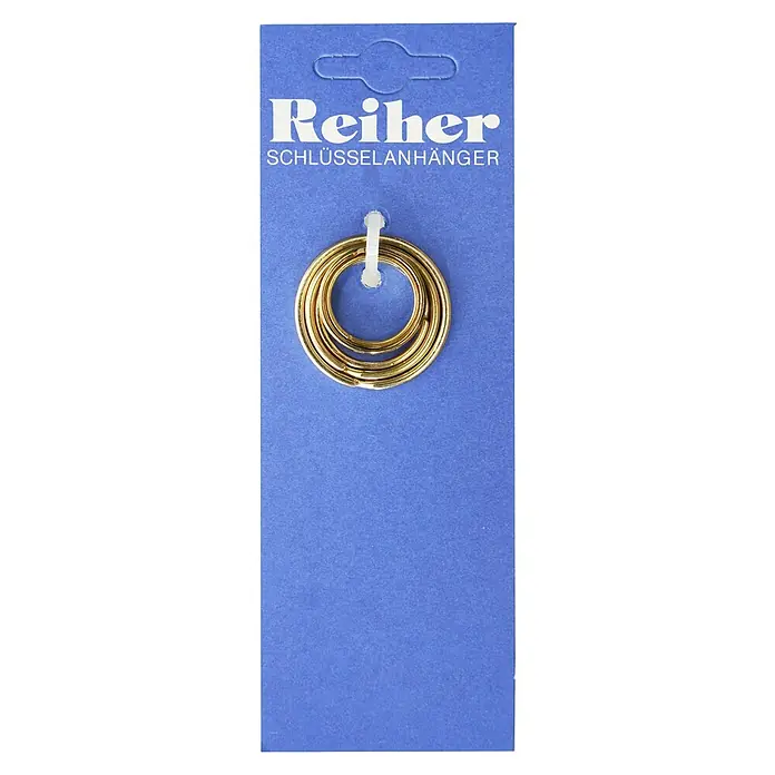 Reiher Schlüsselring-Set5 Stk., Vermessingt - Schlüsselanhänger von Reiher auf blauem Karton. Die Anhänger sind goldfarben und ineinander verschlungen, befestigt mit einem Plastikstreifen.