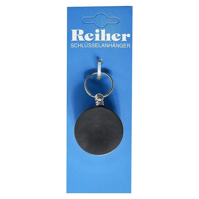 Reiher Schlüsselanhänger - Ø x L: 40 x 600 mm, Gürtelclip, Schwarz, Silber - Schlüsselanhänger "Reiher" in Blau. Der Anhänger hat eine runde, schwarze Fläche, die am Schlüsselring befestigt ist, präsentiert auf blauem Karton.