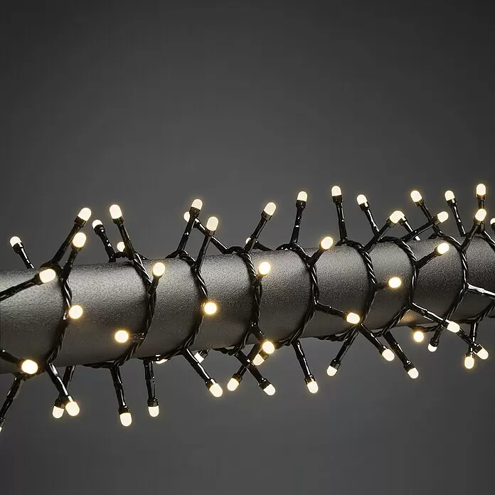 Konstsmide LED-Lichterkette Micro Compact - 11,78 m, Anzahl Leuchtmittel: 400 Stk., Netzbetrieben, 6 W - Warmweiße LED-Lichterkette mit schwarzem Kabel um dunkles Rohr gewickelt.