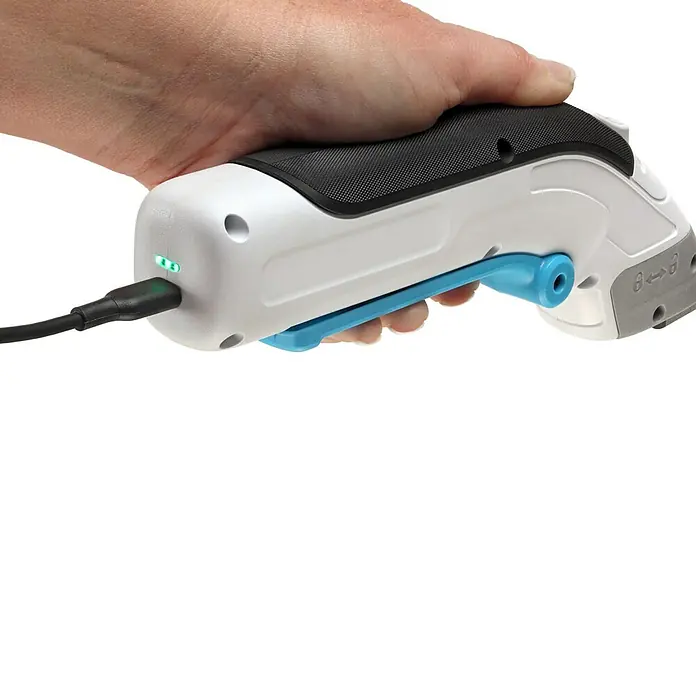 Black+Decker Grapadora de batería BCN115-XJ-Li - 3,6 V, 1 batería, 1,5 Ah - Una mano sujetando un cúter eléctrico inalámbrico en blanco y negro con una palanca azul mientras se carga.