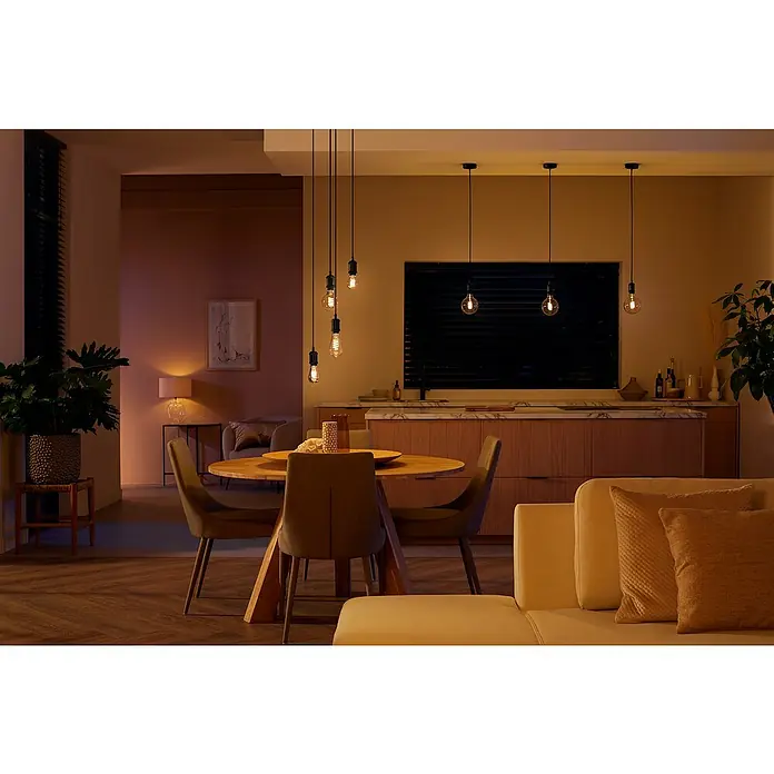 Philips Hue Bombilla LED inteligente Globo gigante - E27, Intensidad regulable, Blanco cálido, 550 lm, 7 W, Denominación de la lámpara: G125 - Un comedor acogedor con bombillas decorativas que emiten una luz cálida y crean un ambiente acogedor.