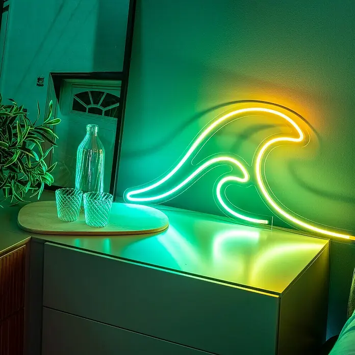 Twinkly LED-Lichtschlauch Flex - Länge: 2 m, Lichtfarbe: RGB, 15 W - Stimmungsvolles Ambiente mit einer wellenförmigen Neonleuchte in Gelb- und Grüntönen, die auf einem Nachttisch platziert ist und ein warmes Licht verbreitet.