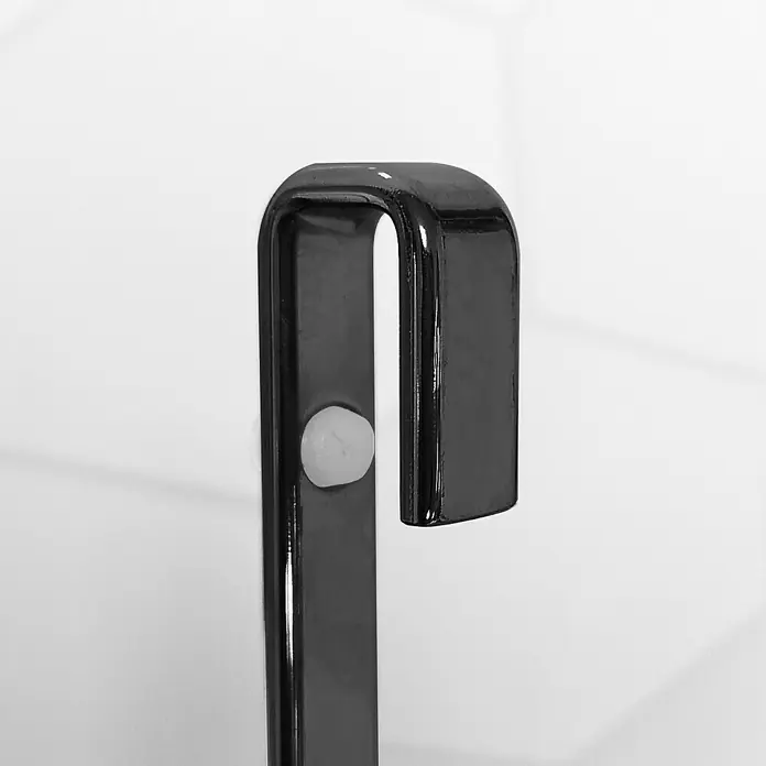 Cesta de baño mampara -  - Primer plano de un toallero de metal negro curvado con un botón blanco fijado a una pared.