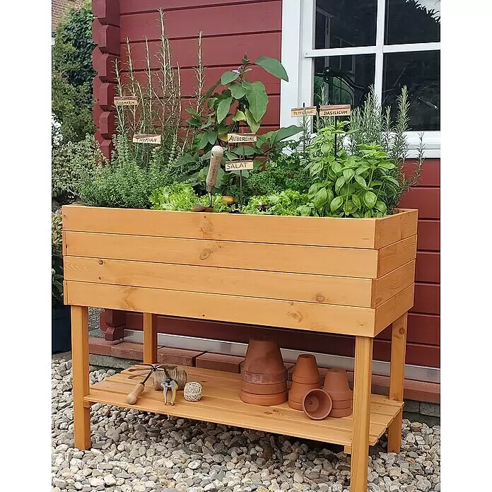 Promadino Kräuterhochbeet - L x B x H: 100 x 50 x 80 cm, Honigbraun - Erhöhtes Hochbeet aus hellem Holz mit Pflanzen und einer Ablage für Gartengeräte.