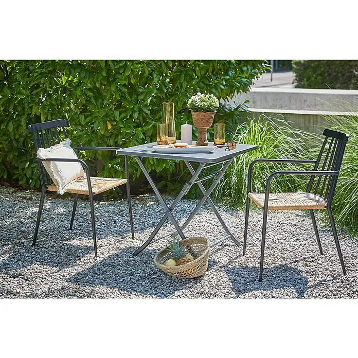 Sunfun Balkonmöbel-Set Maja/Eva - 3 -tlg., Stahl, Aluminium/Rattan, Anthrazit/Schwarz/Natur - Gartenszene mit einem grauen Tisch, umgeben von zwei Stühlen mit Rattan-Sitzen, und dekorativen Elementen auf einem Kiesboden.