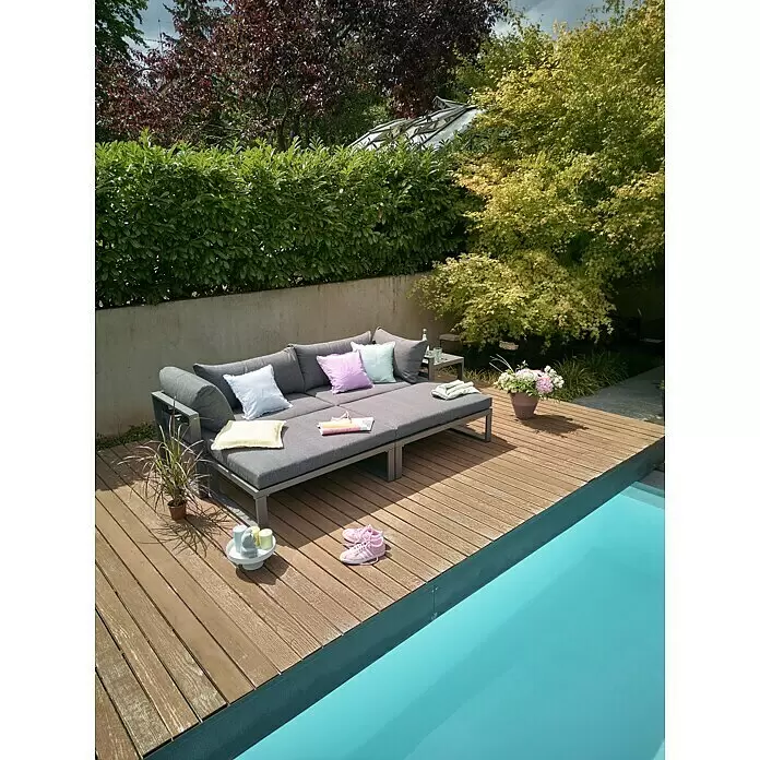 Sunfun Maja Loungemöbel-Set - 5 -tlg., Aluminium, Anthrazit - Graues Outdoor-Sofa/Tagesbett mit bunten Kissen auf einer Holzterrasse am Pool, umgeben von Grün.