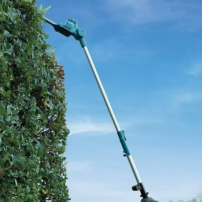 Makita LXT 18V Akku-Heckenschere DUN461WZ - 18 V, Li-Ionen, Ohne Akku, Schnittlänge: 46 cm - Makita Langstiel-Heckenschere in Türkis und Silber schneidet eine hohe Hecke vor blauem Himmel.