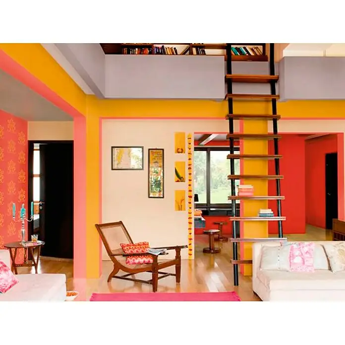 Bruguer Colores del Mundo Pintura para paredes - Perú piedra intermedio, Mate, 4 l - Interior colorido con escalera de librería. La habitación está decorada en tonos de amarillo, rosa y rojo. La escalera conduce a una pequeña librería.
