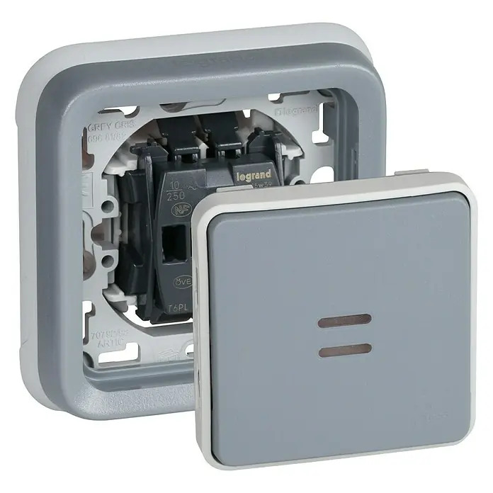Legrand Plexo Pulsador para estancias con humedad con luz - Gris, Instalación empotrada, IP55 - Primer plano de un interruptor Legrand gris con marco blanco, parcialmente abierto que revela la mecánica interna.