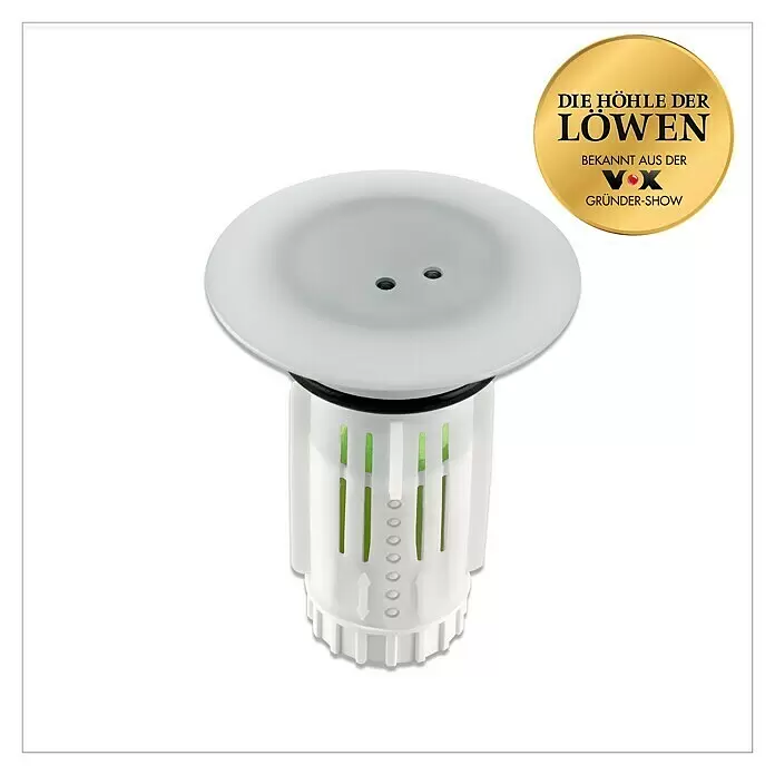 Abfluss-Fee Verschlussstopfen mit LED - Mit Duftstein, Waschbecken - Weißer zylindrischer Abflusssieb mit breiter, flacher Oberseite, grünen Innenelementen sichtbar durch seitliche Schlitze und einer goldenen 'Die Höhle der Löwen' Medaille.