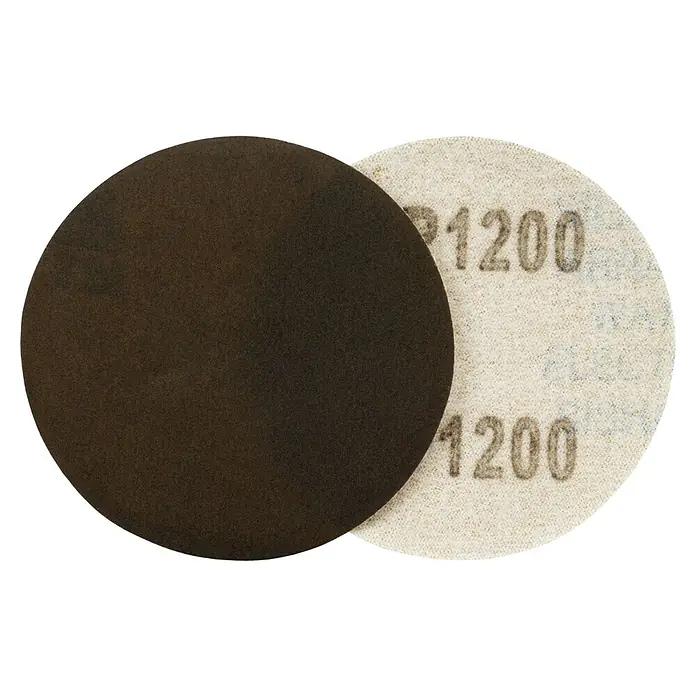 Juego de reparación de faros - 9 pzs. - Primer plano de dos discos de lijado, uno oscuro y otro etiquetado como "1200", sobre un fondo negro.