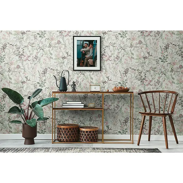 A.S. Création Vliestapete Blüten - Pastell, Floral, 10,05 x 0,53 m - Elegantes Interieur mit einem Konsolentisch, Dekorationen, einer Zimmerpflanze und einem stilvollen Stuhl vor einer floralen Tapete.