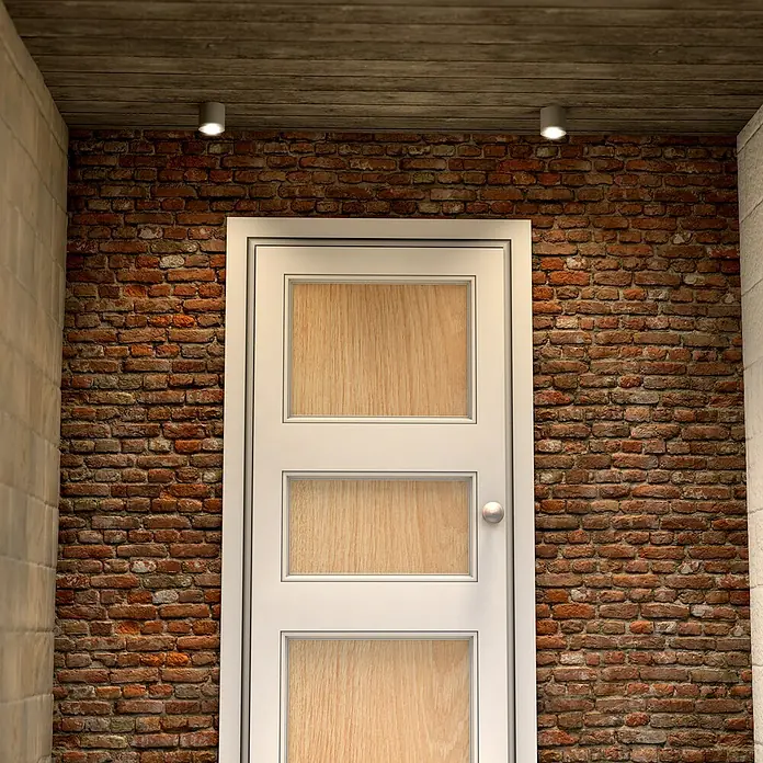 Alverlamp Foco de pared de superficie basculante - Negro, GU10, Ø x Al: 8 x 8,5 cm - Vista interior de una puerta moderna con paneles de madera y marco blanco, iluminada por dos luces de techo contra una pared de ladrillo.