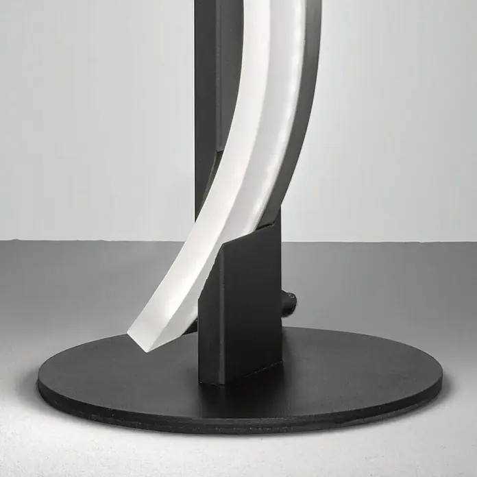 Fischer & Honsel LED-Tischleuchte - 7 W, L x B x H: 25,5 x 25 x 25 cm, schwarz matt, Warmweiß - Detailaufnahme einer modernen Stehleuchte mit geschwungenem, weißem Lichtelement und schwarzem Fuß. Elegantes Design für stilvolle Innenräume.