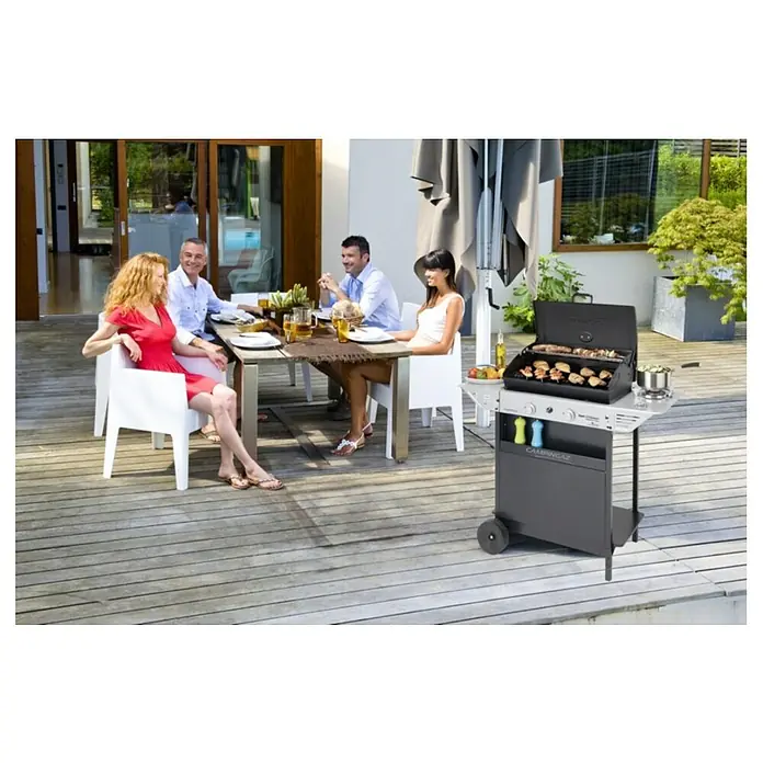 Campingaz Barbacoa de gas XPERT 200 LS Plus Rocky - Superficie de la parrilla (An x Pr): 54,5 x 34,5 cm, 8,2 kW, Número de quemadores: 2 - Parrilla Campinaz gris con comida a la parrilla al aire libre. La parrilla cuenta con una superficie de cocción, estantes laterales y porta botellas de gas.