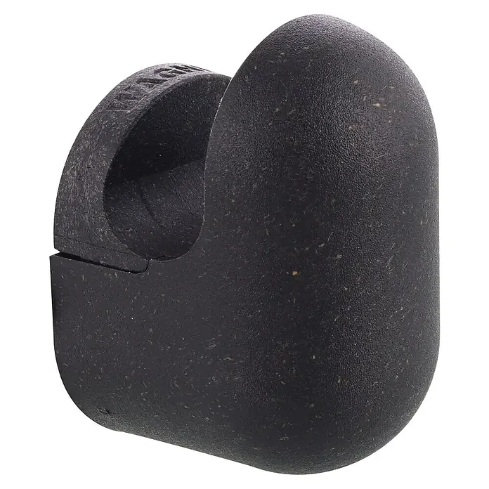 Wagner System Garderobenhaken-Set PILL - L x B x H: 37 x 31 x 51 mm, Schwarz, 4 Stk. - Nahaufnahme eines schwarzen MAGPED-Kabelschutzes mit einer Öffnung zur Aufnahme des Kabels und feinen Sprenkeln in der Oberfläche.