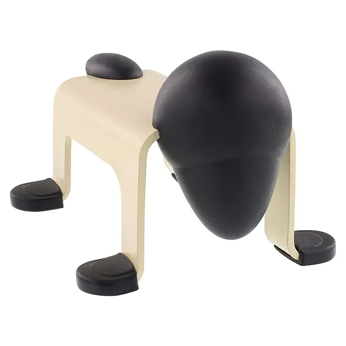 Wagner System Bodentürstopper EH5206 - L x B x H: 59 x 106 x 71 mm, Stahl, Gelb - Eine Nahaufnahme eines dekorativen hölzernen Türstoppers in Hundeform, beige mit schwarzen Akzenten.