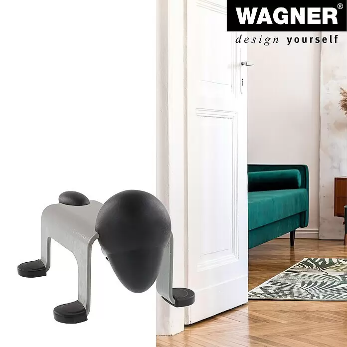 Wagner System Bodentürstopper EH5207 - L x B x H: 59 x 106 x 71 mm, Stahl, Grau - Grauer Türstopper mit schwarzen Gummifüßen und einem großen schwarzen Gummikopf, der eine weiße Tür offen hält.