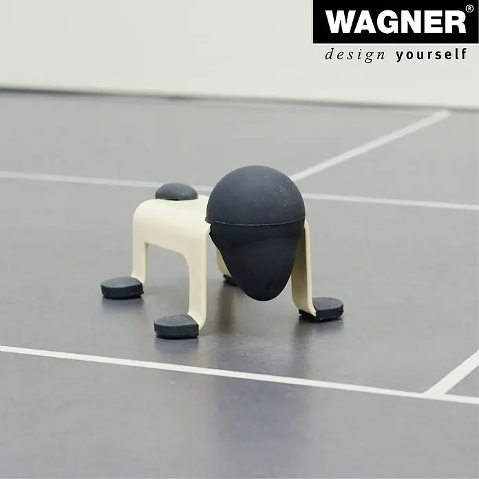Wagner System Bodentürstopper EH5206 - L x B x H: 59 x 106 x 71 mm, Stahl, Gelb - Wagner Möbelgleiter mit speziellem Design. Er besteht aus beigen Beinen und schwarzen Füßen.