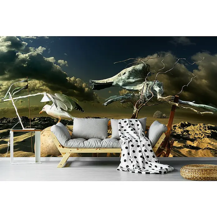 Papermoon Premium collection Fototapete Möwe in der Wüste - B x H: 500 x 280 cm, Vlies - Gemütliches Sofa mit Kissen und einer Decke mit schwarzen Punkten vor einer surrealen Hintergrundkulisse.