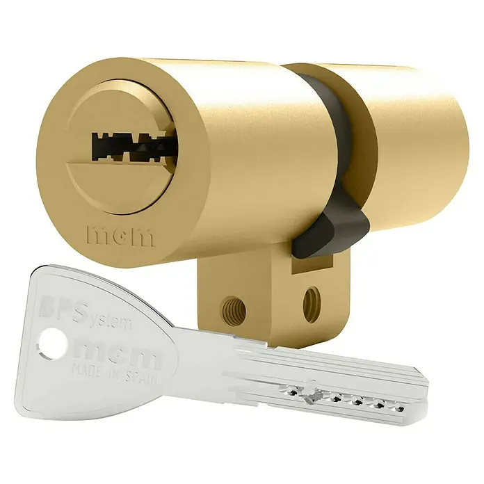 MCM Cilindro de perfil de seguridad SP - Longitud total interior: 33 mm, Longitud total exterior: 33 mm, Número de llaves: 5 ud. - Primer plano de un cilindro de bloqueo MCM con llave. La cerradura de alta calidad brinda seguridad y confiabilidad a su hogar.