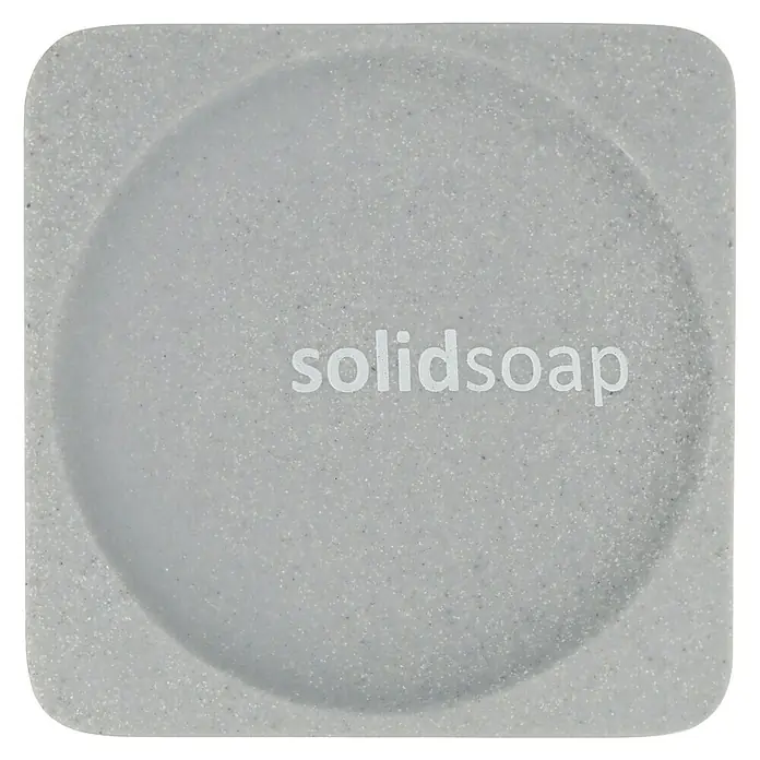 Venus Cooper Seifenschale - Polyresin, Grau - Nahaufnahme eines grauen "solidsoap" Produkts, das die Textur und den Markennamen hervorhebt.
