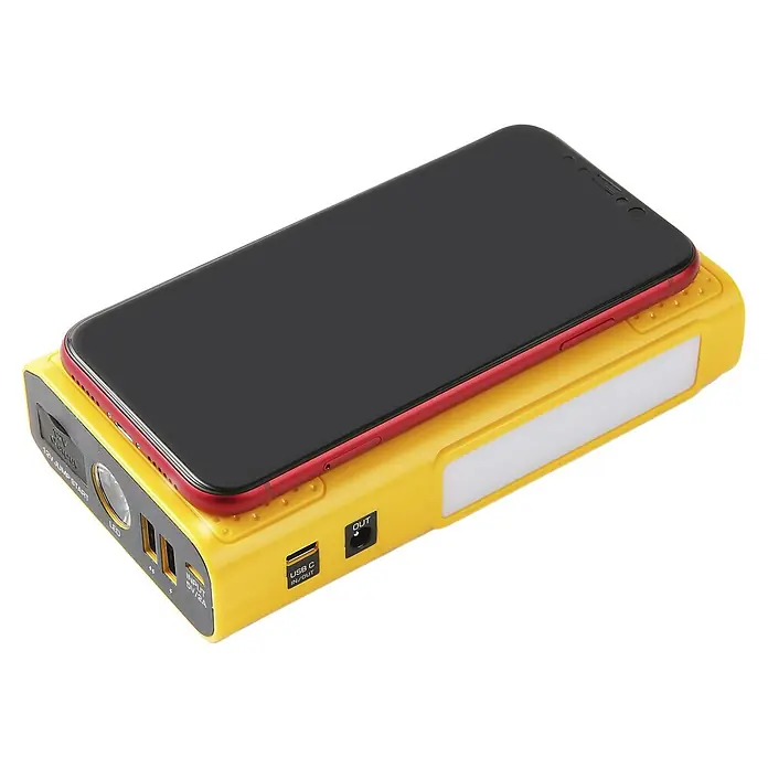 Kit de arranque HUMMH3T - 12 V, 3 Ah - 8 Ah - La imagen muestra un arrancador amarillo con un teléfono inteligente encima.