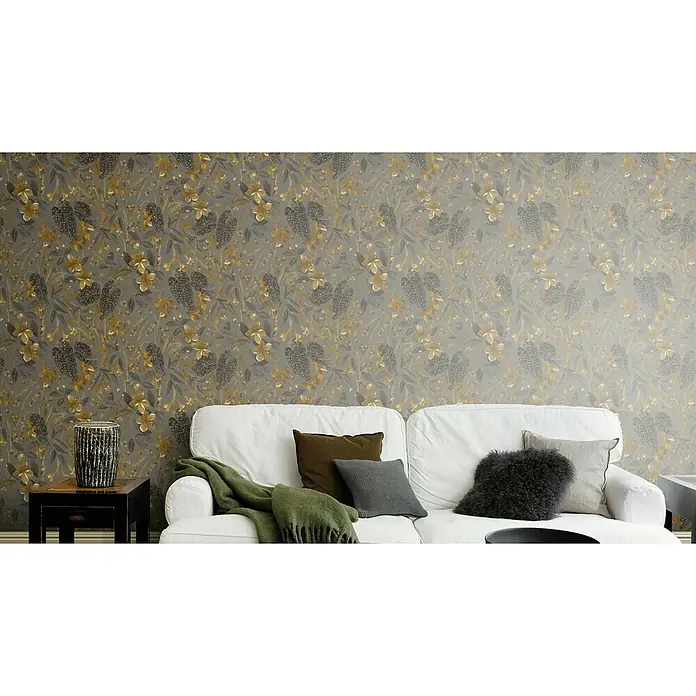 Rasch Curiosity Vliestapete Blume - Bronze, Floral, 10,1 x 0,53 m - Elegantes Interieur mit floraler Tapete, weißem Sofa mit Kissen und Beistelltisch. Das stilvolle Design verleiht dem Raum eine besondere Note.