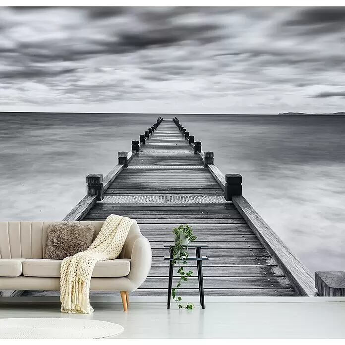 Papermoon Premium collection Fototapete Beinbar - B x H: 200 x 149 cm, Vlies - Schwarz-weißes Wandbild eines langen Holzstegs im Meer unter bewölktem Himmel, als beruhigende Wohnzimmerkulisse.