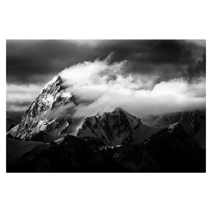 Papermoon Premium collection Fototapete Felsen und Wind - B x H: 300 x 223 cm, Vlies - Verschneite Berggipfel ragen in den Himmel, umhüllt von dramatischen Wolken, die eine atemberaubende monochrome Landschaft schaffen.