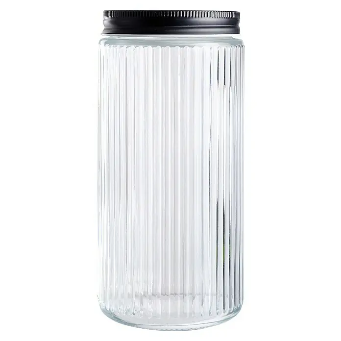 Frasco con relieve - Ø x Al: 9,2 x 19,5 mm, 900 ml, Vidrio - Primer plano de un recipiente de vidrio acanalado con tapa negra, ideal para guardar alimentos o como elemento decorativo. Elegante y funcional.