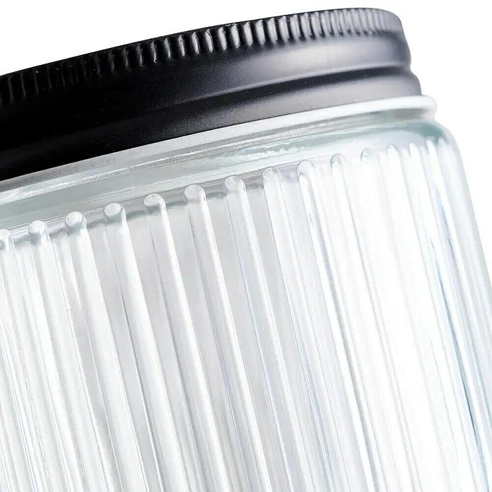 Frasco con relieve - Ø x Al: 9,2 x 11,2 mm, 500 ml, Vidrio - Primer plano de un tarro de cristal con diseño acanalado y tapa negra, ideal para un almacenamiento elegante.