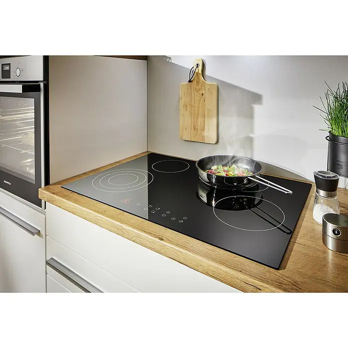 Respekta Premium Composición de cocina Gabriel - Ancho: 320 cm, Blanco, Con electrodomésticos - Una vista de cerca de una placa de cocina moderna con una olla de cocina montada en ella, en un mostrador de cocina.
