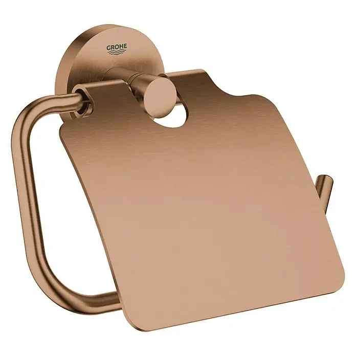 Grohe Essentials Toilettenpapierhalter - Mit Deckel, Warm Sunset, Matt - Nahaufnahme eines GROHE Essentials Toilettenpapierhalters in gebürstetem Rotgold, ein elegantes Badaccessoire.