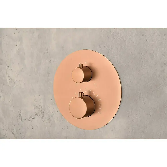 Camargue Natur Sistema de ducha empotrado - Con grifo termostático, Oro Rosa - Grifo de ducha moderno en oro rosa con dos mandos redondos para control de temperatura y flujo de agua montado en pared gris.