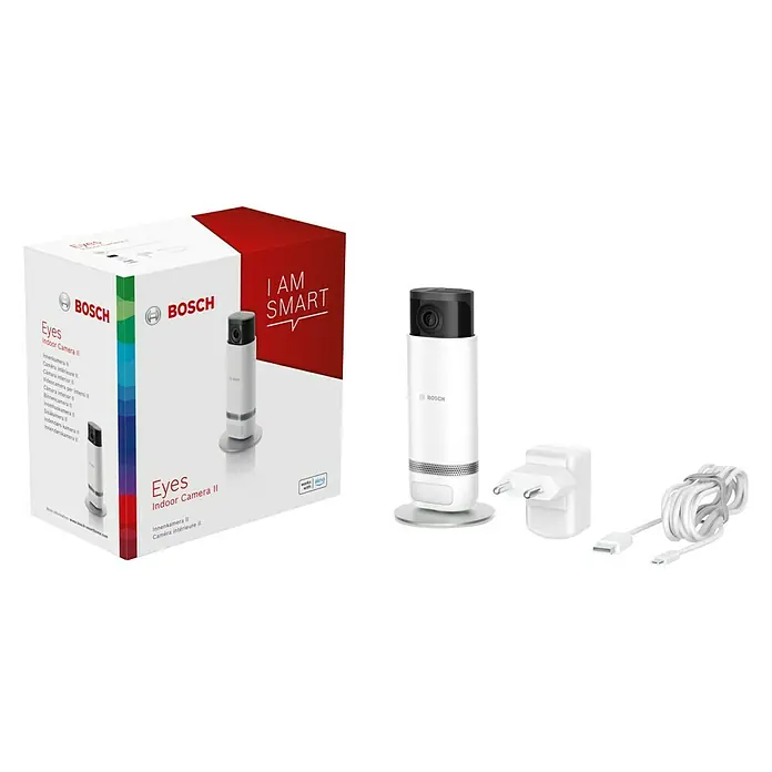 Bosch Smart Home Innenkamera Eyes II - Netzbetrieben, L x B x H: 160 x 72 x 160 mm, 1.920 x 1.080 Pixel (Full HD), Reichweite Funk: 0 m - 99 m - Produktaufnahme der Bosch Eyes Indoor Camera II mit Verpackung, Netzteil und Kabel.