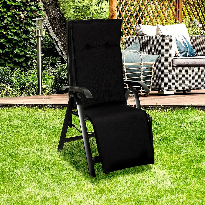 beo Gartenmöbel-Auflage Trabzon - Relaxsesselauflage, L x B x H: 171 x 46 x 8 cm, Baumwolle, Polyester, Schwarz - Ein stilvoller schwarzer Liegestuhl auf einem grünen Rasen, perfekt für entspannte Stunden im Garten oder auf der Terrasse.