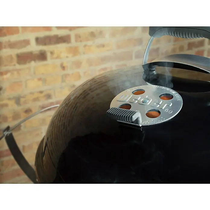 Weber Barbacoa de carbón Performer premium GBS 57 - Diámetro de la superficie de la parrilla: 57 cm, Negro - Primer plano de una barbacoa Weber con ventilación y asa, ideal para los amantes de las parrillas que valoran la calidad.