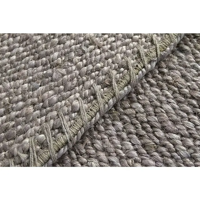 Alfombra de yute Córdoba - Gris, 230 x 160 cm, 100% yute - Primer plano de una alfombra gris tejida con un borde decorativo, que destaca la textura y la artesanía.