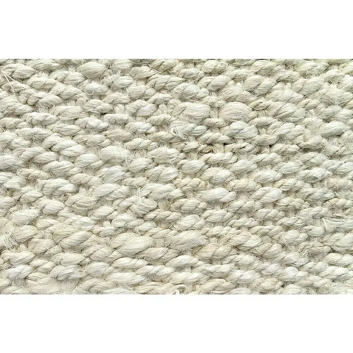 Alfombra de yute Córdoba - Blanco, 170 x 120 cm, 100% yute - Primer plano de una alfombra tejida que muestra una superficie densa y texturizada hecha de hilos blancos gruesos. La textura se ve táctil y atractiva.