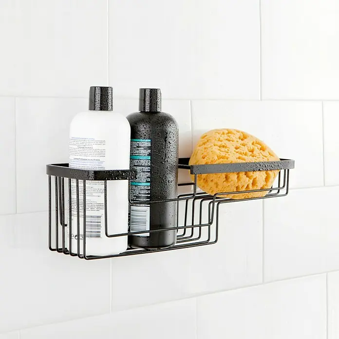 Tatay Aluminium Cesta de baño rectangular - 12 x 37 x 11,5 cm, Negro - Cesta de alambre negra con dos botellas y una esponja en una pared de azulejos blancos.