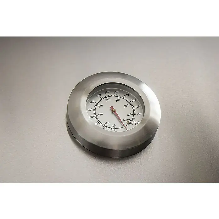 Barbacoa de gas Fidgi - Superficie de la parrilla (An x Pr): 57,5 x 42 cm, 11,5 kW, Número de quemadores: 3 - Primer plano de un termómetro de parrilla que muestra una temperatura de aproximadamente 315 grados Fahrenheit, incrustado en una superficie metálica.