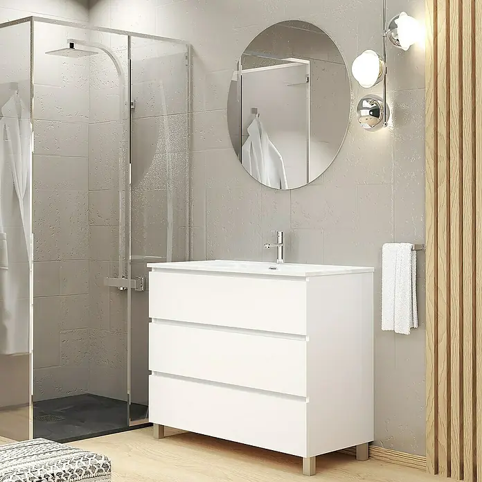 Artysan Conjunto de mueble de baño Basic 3C - Ancho: 100 cm, Ancho total del mueble de baño: 100 cm, Blanco, Mate, 3 pzs. - Imagen de una combinación de tocador de baño moderno con tres cajones en blanco, complementada con un espejo redondo e iluminación elegante.