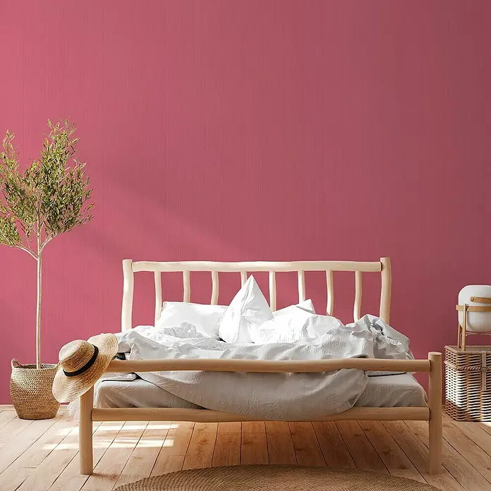 A.S. Création Michalsky 4 VliestapeteRot, Uni, 10,05 x 0,53 m - Schlafzimmer Interieur mit einem hellen Holzrahmenbett, weißer Bettwäsche und einem Strohhut für eine entspannte Atmosphäre.